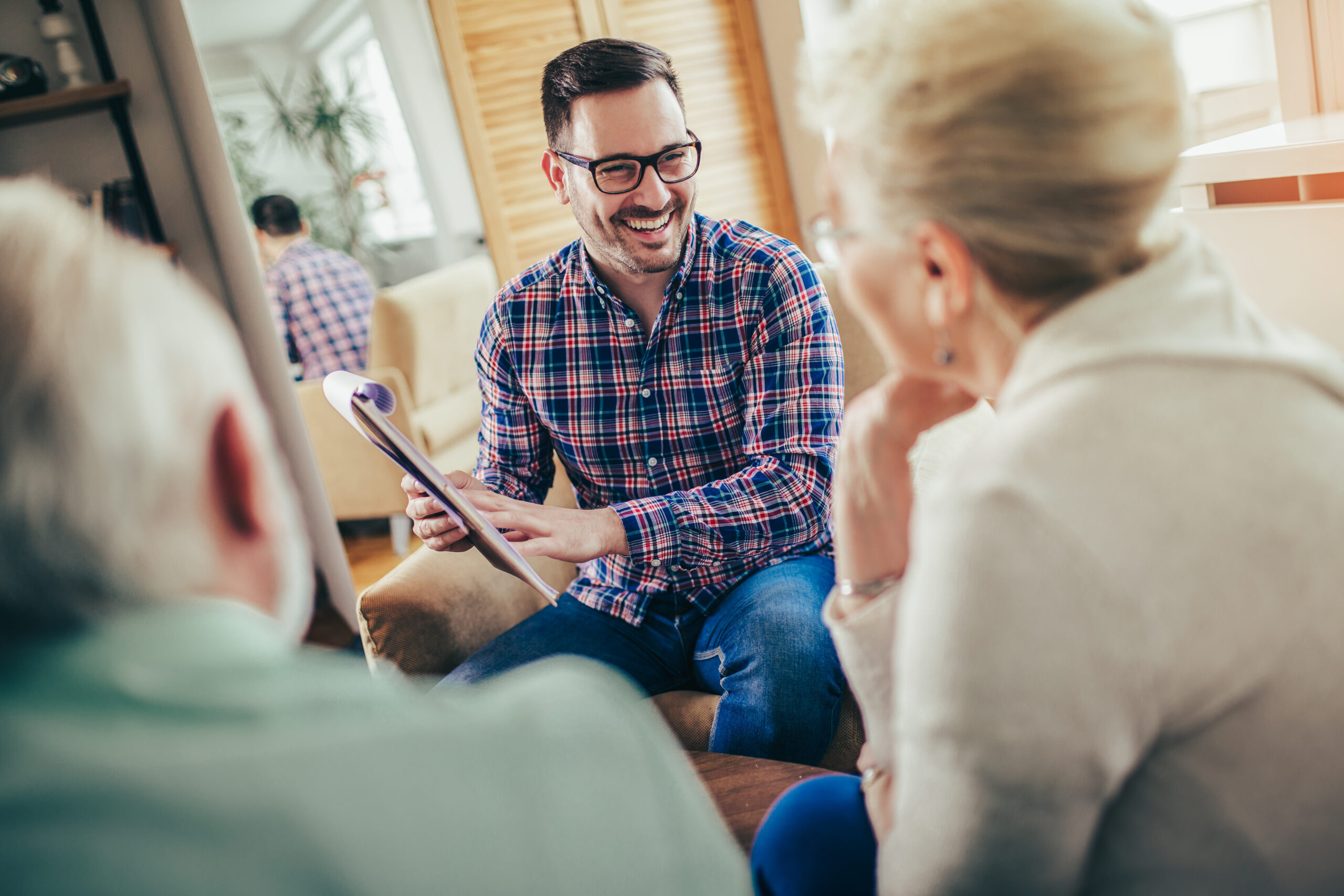 Positive aged couple consulting with insurance agent
